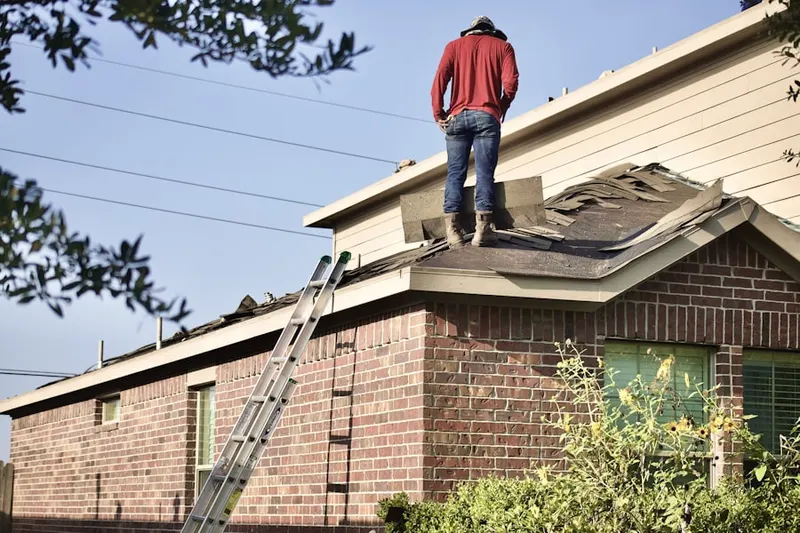 Professional roofer working on a residential roof in New Gretna